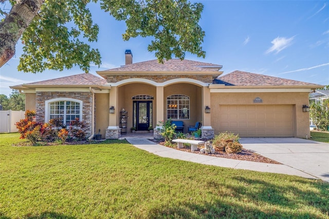 view of front facade featuring a garage and a front lawn