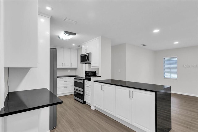 kitchen with light wood-type flooring, white cabinetry, and stainless steel appliances