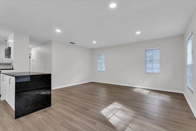 unfurnished living room with hardwood / wood-style floors