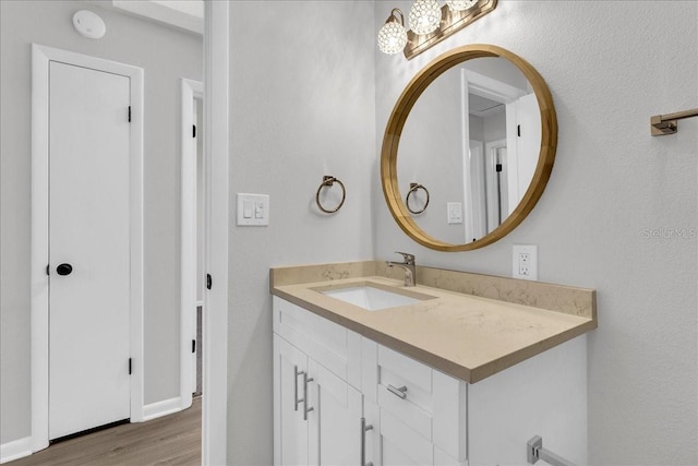 bathroom with hardwood / wood-style flooring and vanity