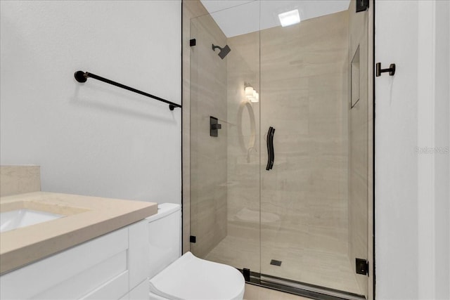 bathroom with an enclosed shower, vanity, and toilet