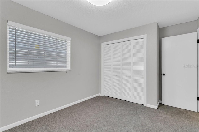 unfurnished bedroom with a closet, carpet, and multiple windows