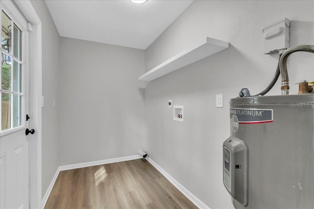 clothes washing area featuring hookup for an electric dryer, electric water heater, washer hookup, and light hardwood / wood-style flooring