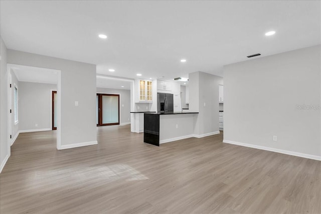 unfurnished living room featuring light wood-type flooring