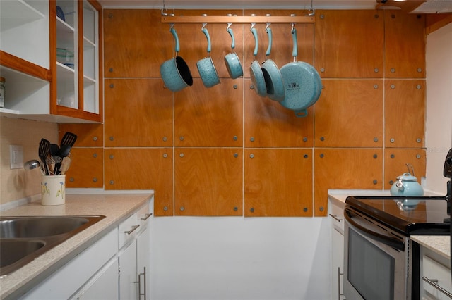 kitchen with white cabinetry and electric range