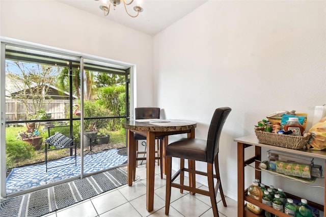 tiled dining room with an inviting chandelier