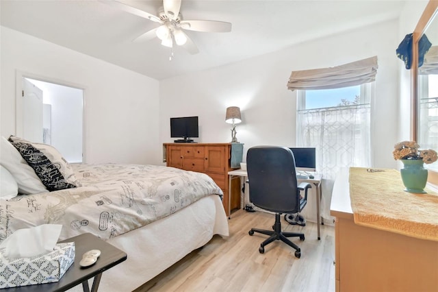 bedroom featuring ceiling fan, multiple windows, and light wood-type flooring