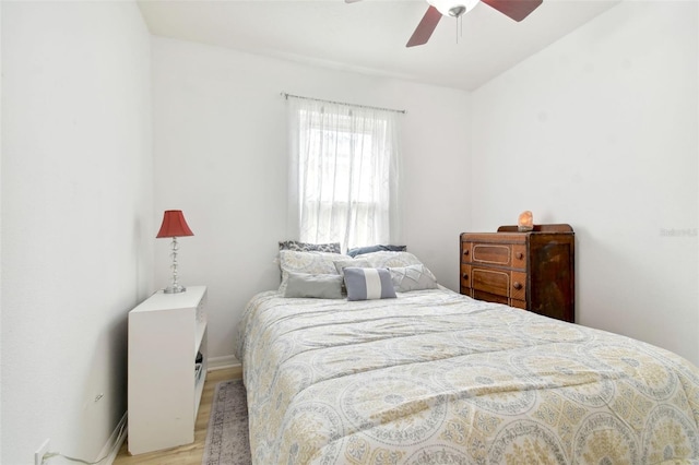 bedroom with ceiling fan and light wood-type flooring