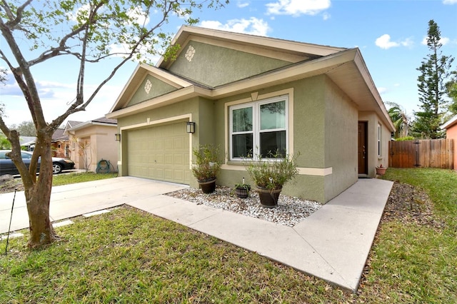 view of front of house featuring a garage and a front lawn