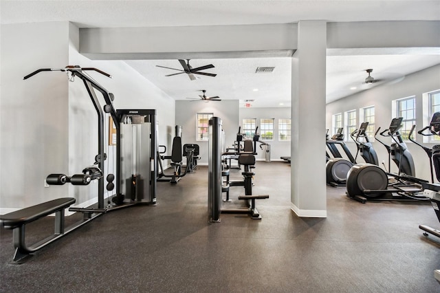 gym with a wealth of natural light and a textured ceiling