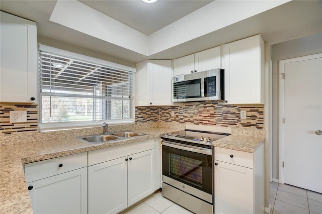 18138 Lake Worth Blvd, Port Charlotte, FL 33948 - kitchen featuring stainless steel appliances, a sink, light tile patterned flooring, and light countertops