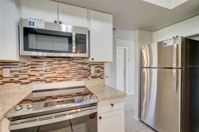 18138 Lake Worth Blvd, Port Charlotte, FL 33948 - kitchen featuring appliances with stainless steel finishes, light tile patterned floors, white cabinetry, and decorative backsplash