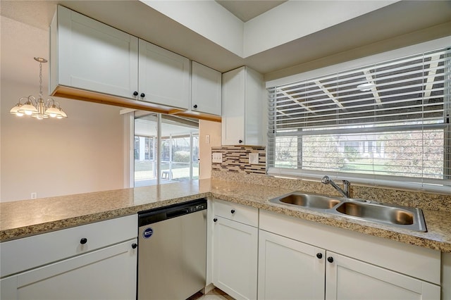 kitchen featuring white cabinets, sink, an inviting chandelier, decorative light fixtures, and dishwasher