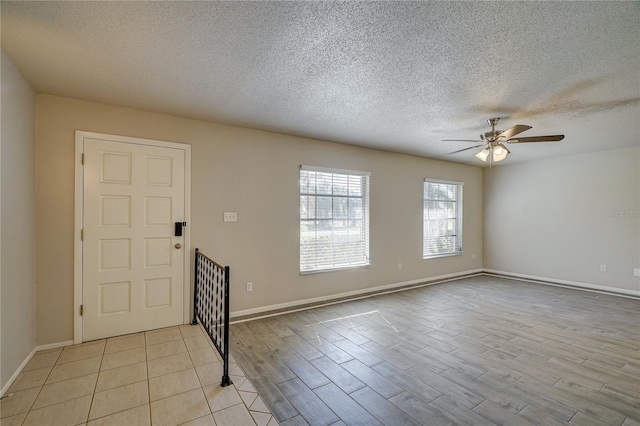 18138 Lake Worth Blvd, Port Charlotte, FL 33948 - entrance foyer with a ceiling fan, a textured ceiling, light wood finished floors, and baseboards
