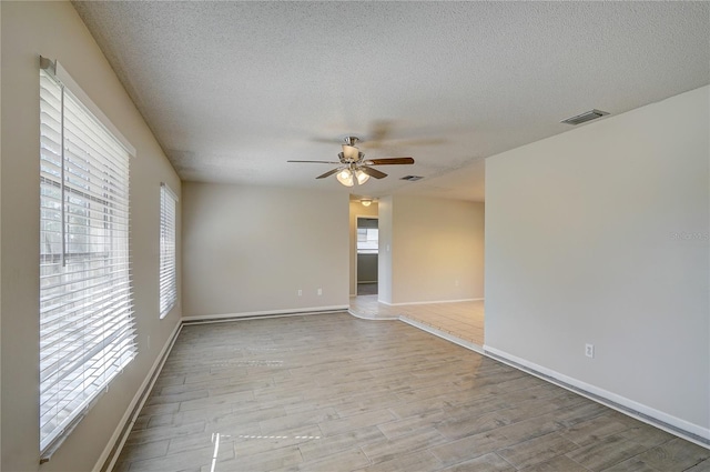 18138 Lake Worth Blvd, Port Charlotte, FL 33948 - spare room with a textured ceiling, ceiling fan, wood finished floors, and baseboards