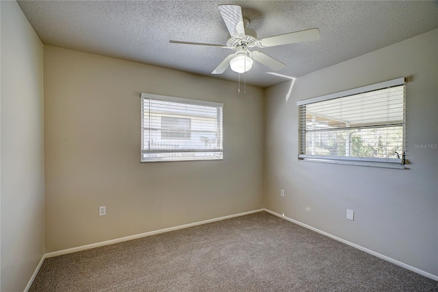 unfurnished room featuring a textured ceiling, carpet floors, and ceiling fan