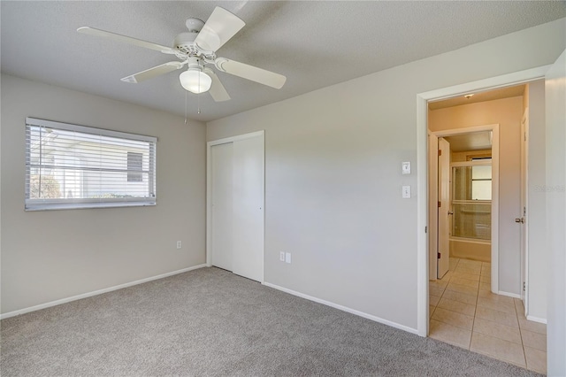 18138 Lake Worth Blvd, Port Charlotte, FL 33948 - unfurnished bedroom with light carpet, baseboards, a closet, a ceiling fan, and light tile patterned floors