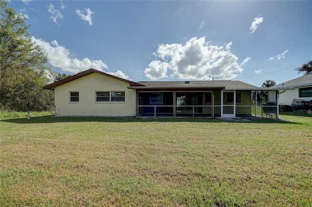 18138 Lake Worth Blvd, Port Charlotte, FL 33948 - rear view of house with a sunroom, a yard, and stucco siding