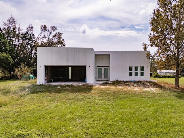 rear view of house featuring a lawn