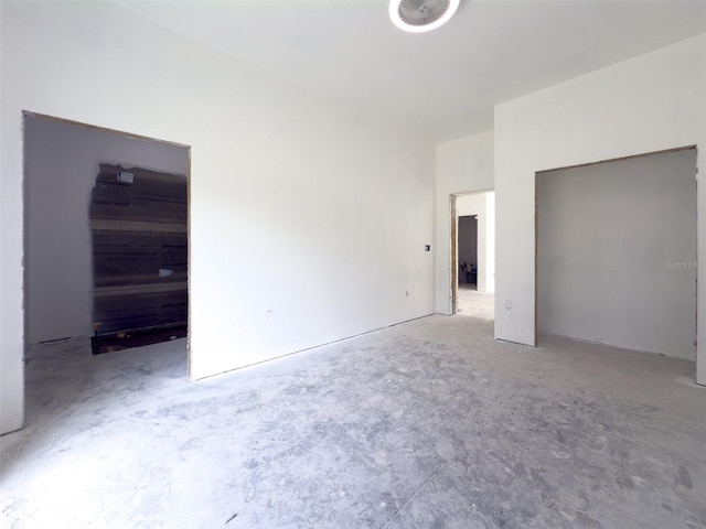 unfurnished bedroom with concrete floors