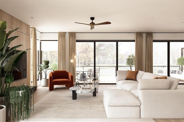 living room featuring ceiling fan and light hardwood / wood-style flooring