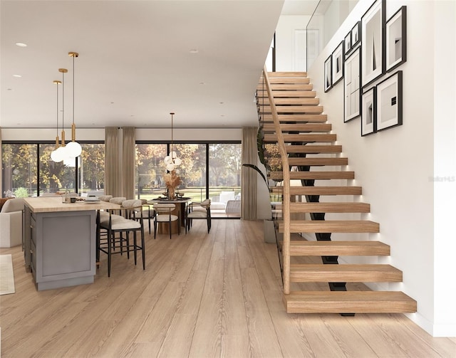 stairway featuring hardwood / wood-style flooring and floor to ceiling windows