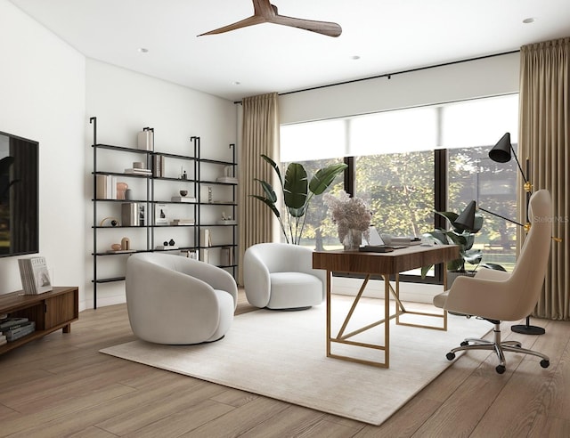 home office with light hardwood / wood-style floors