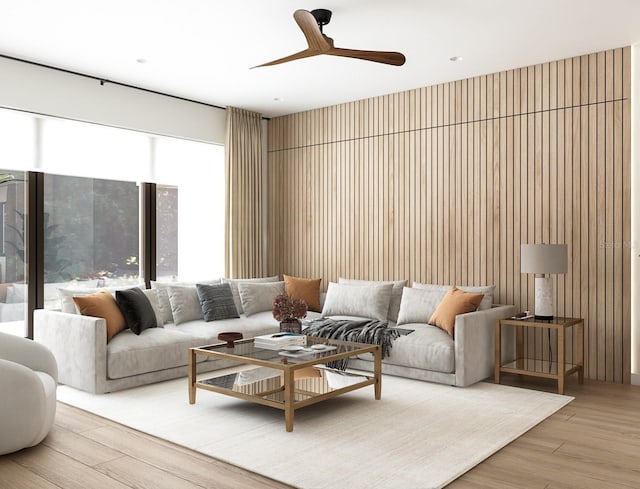 living room featuring light hardwood / wood-style floors, ceiling fan, and wooden walls