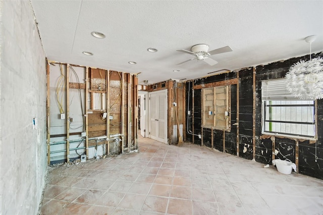 miscellaneous room with a textured ceiling and ceiling fan