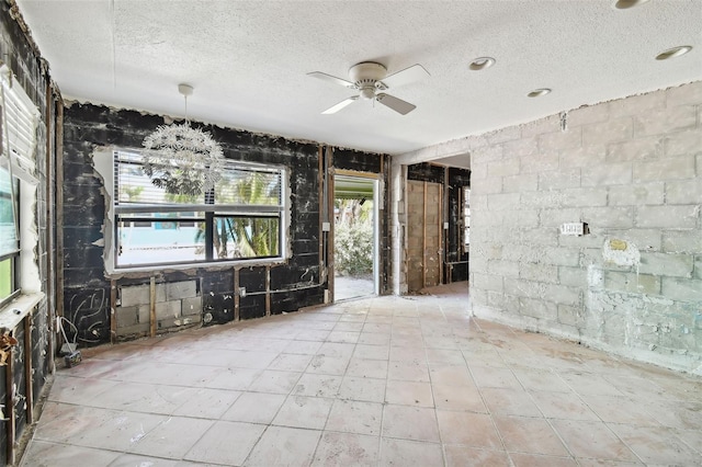 unfurnished room featuring a textured ceiling and ceiling fan