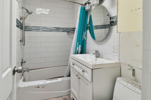 full bathroom featuring toilet, tile walls, tasteful backsplash, vanity, and shower / tub combo