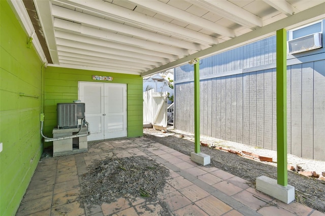 view of patio featuring a wall mounted AC and central AC