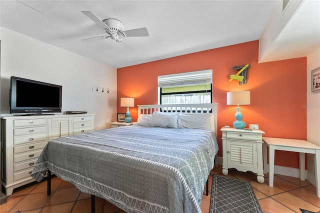 bedroom with light tile patterned flooring, a textured ceiling, and ceiling fan