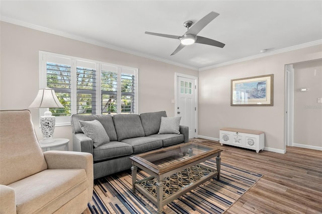 living room with ornamental molding, hardwood / wood-style flooring, and ceiling fan