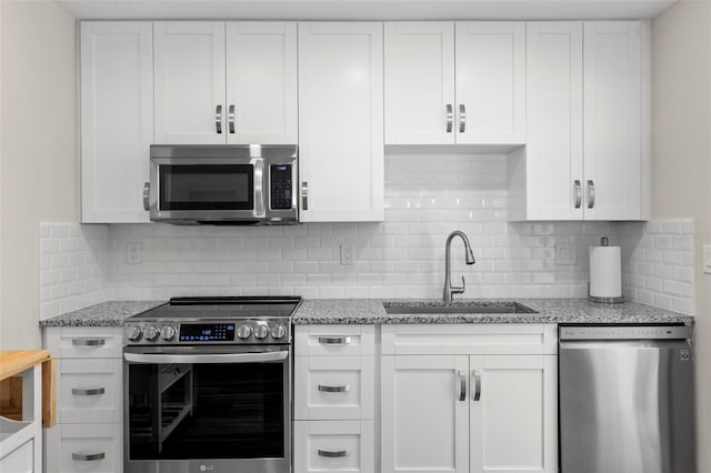 kitchen with white cabinets and appliances with stainless steel finishes