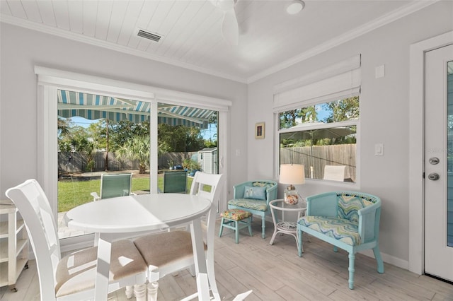 sunroom / solarium featuring ceiling fan