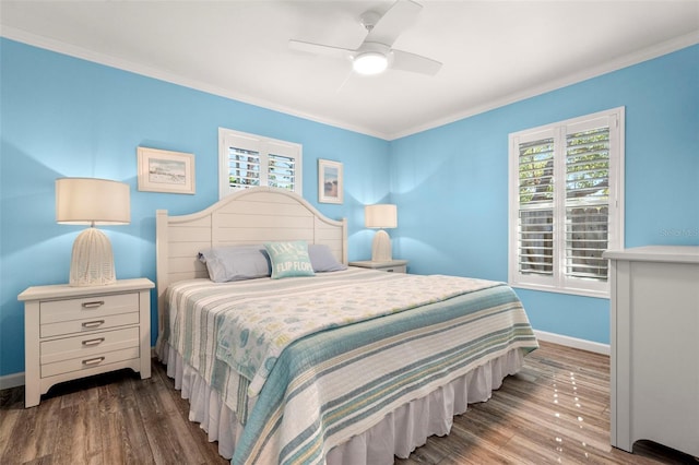 bedroom featuring ornamental molding, dark wood-type flooring, and ceiling fan