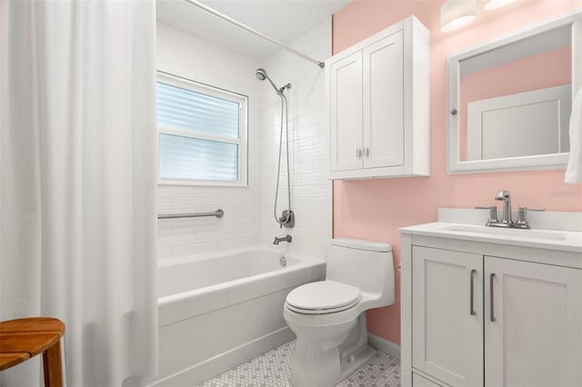 full bathroom featuring vanity, tile patterned floors, toilet, and tiled shower / bath combo