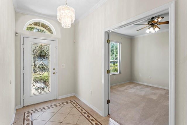 foyer entrance featuring light tile patterned flooring, ceiling fan with notable chandelier, and ornamental molding