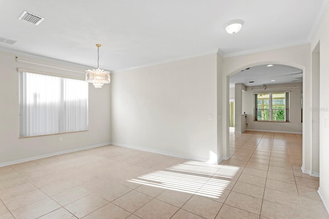 tiled empty room featuring an inviting chandelier and crown molding