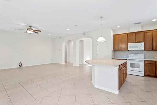 kitchen featuring light tile patterned floors, white appliances, ceiling fan, and pendant lighting