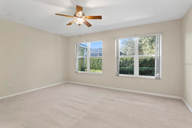 carpeted spare room featuring ceiling fan