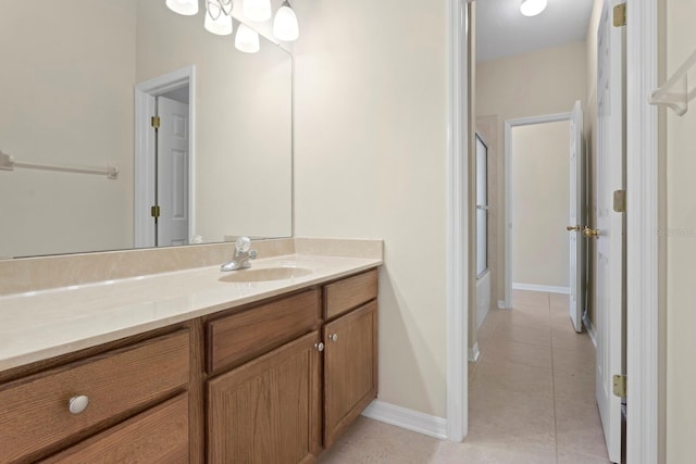 bathroom featuring tile patterned floors, vanity, and walk in shower