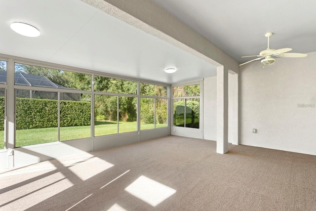 unfurnished sunroom featuring ceiling fan