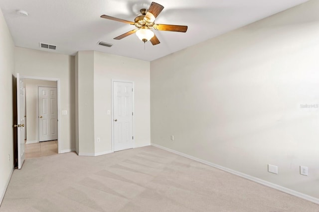 unfurnished bedroom featuring light colored carpet and ceiling fan