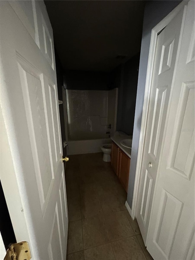 hallway with dark tile patterned flooring