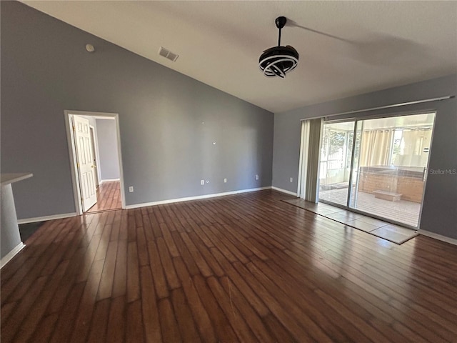 empty room featuring lofted ceiling and dark hardwood / wood-style floors