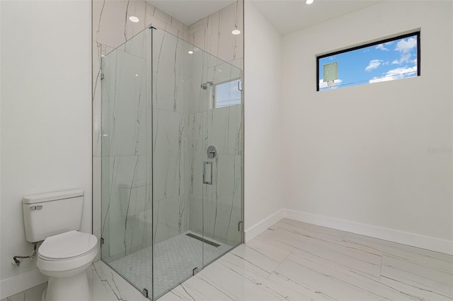 bathroom featuring toilet and an enclosed shower