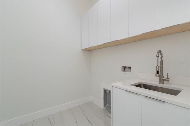 laundry room featuring washer hookup, cabinets, and sink