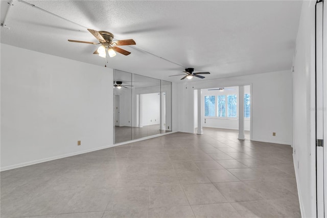 tiled spare room with a textured ceiling